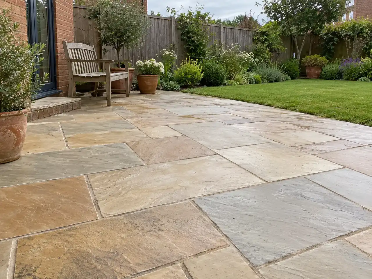 Natural stone patio beside a lawn