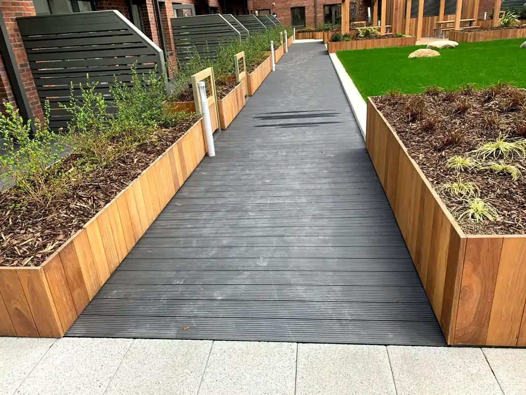 Raised planting beside a decked walkway